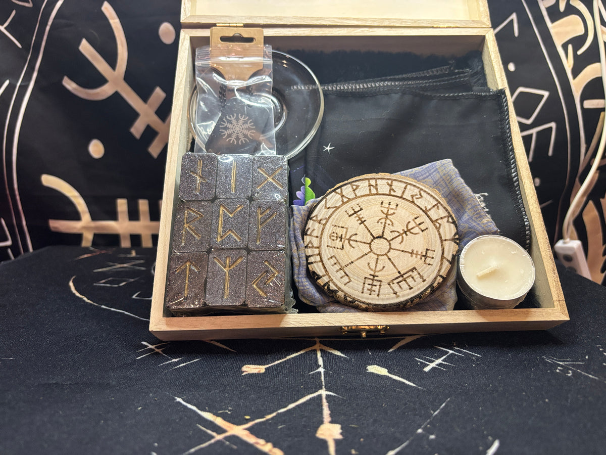 Inside the Wayfarer's Altar travel altar: rune set, Mjolnir pendant, offering tray, candles, and altar cloth